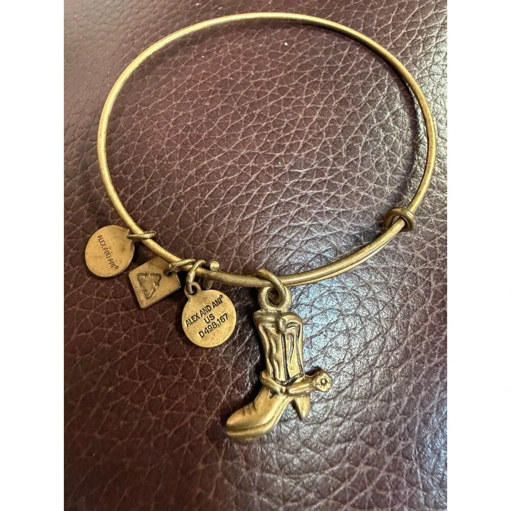Alex and Ani Cowboy Boot charm bracelet featuring a gold-toned expandable bangle